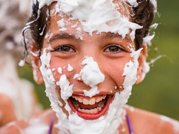 young girl with shaving cream all over her face