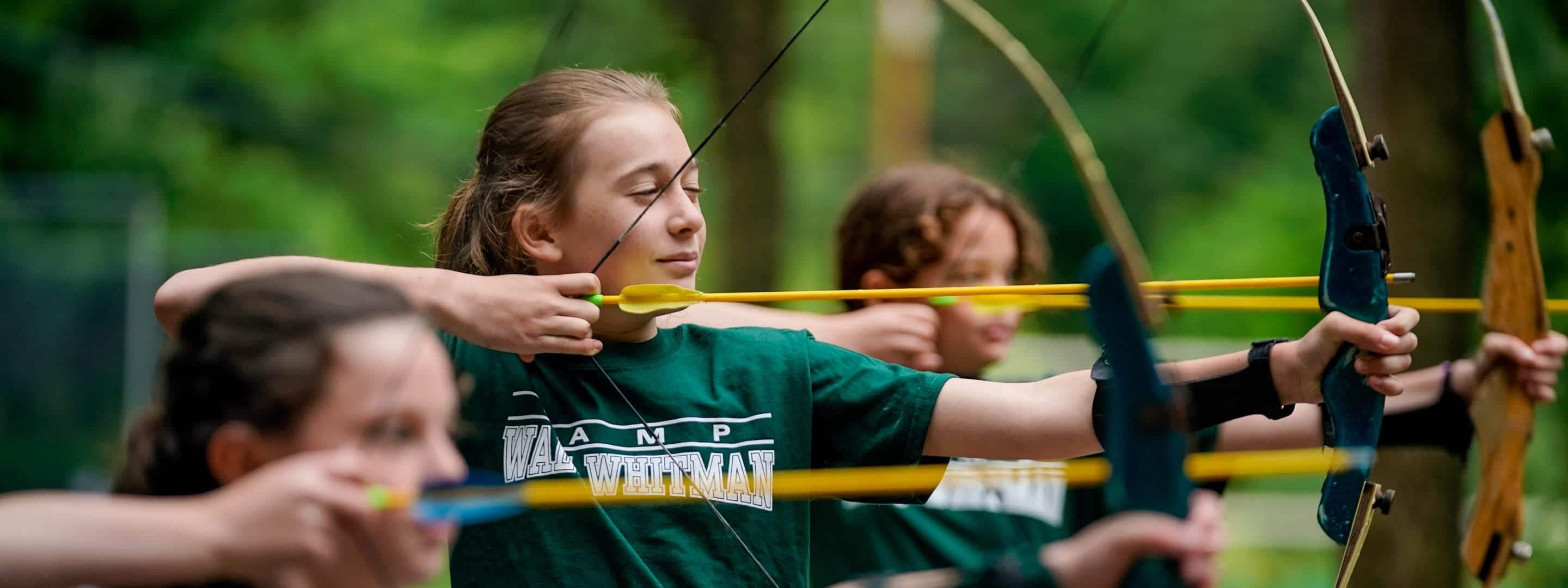 girls shooting a bow and arrow