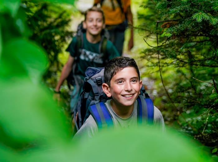 kids hiking through the woods