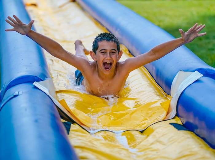 young boy on a slip and slide