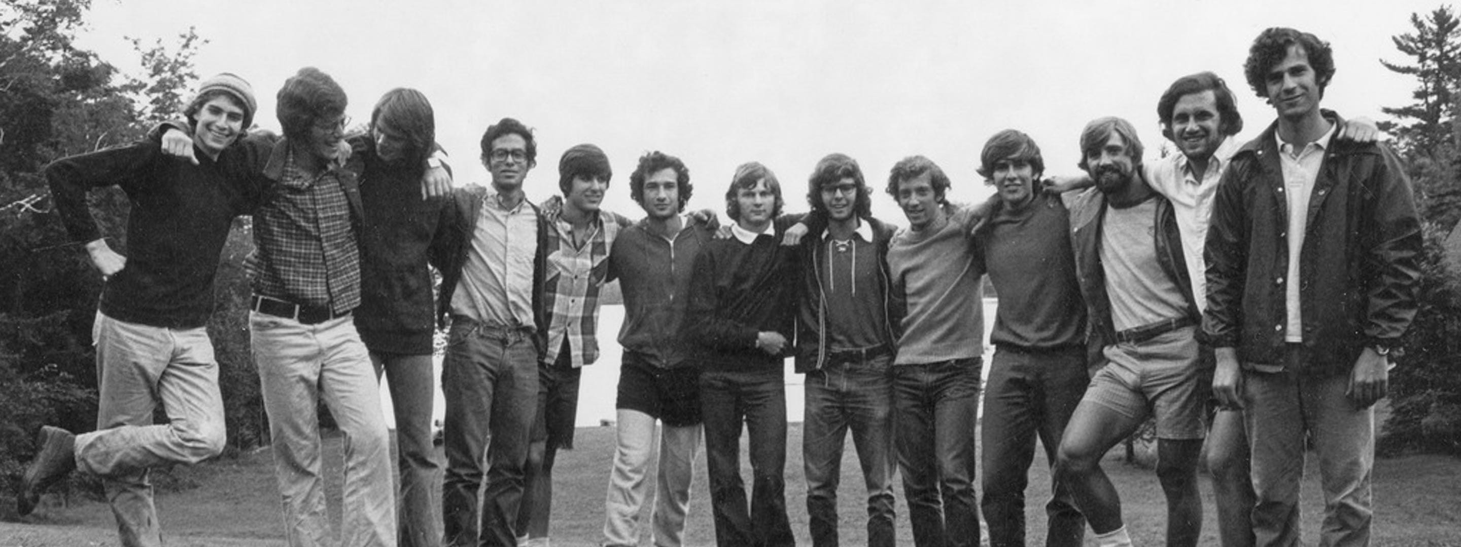 black and white picture of group of young men holding arms