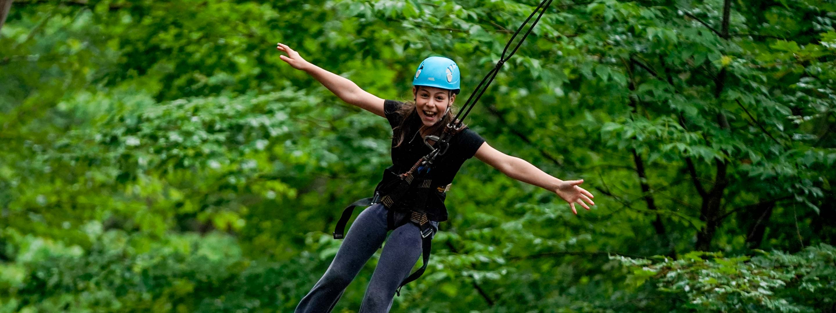 girl smiling while ziplining