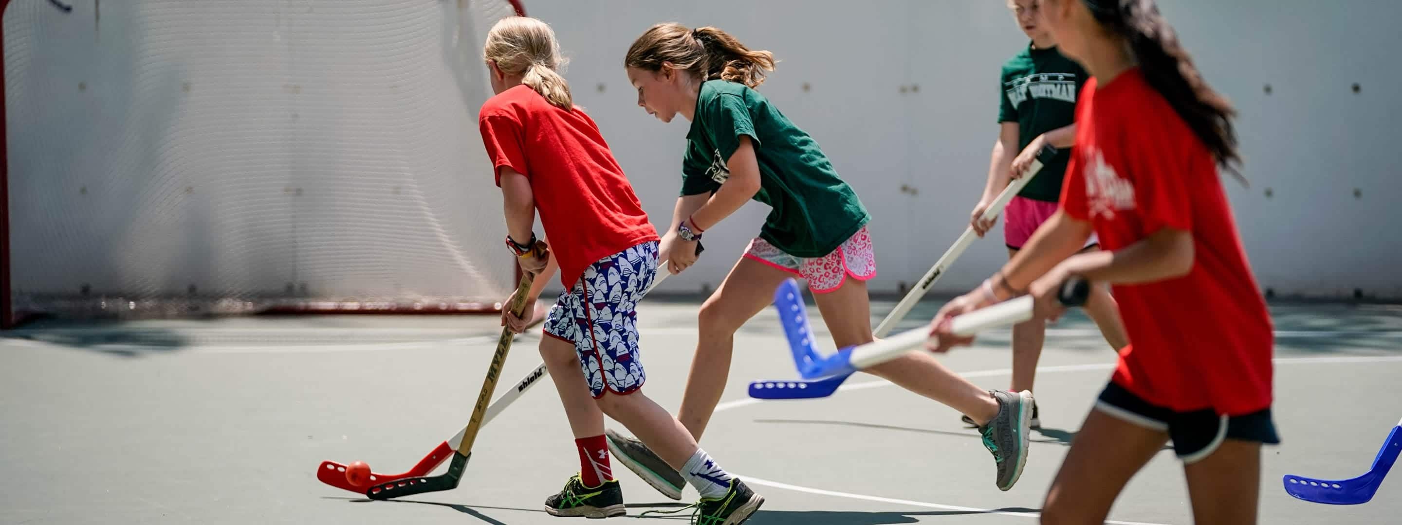 girls playing street hockey