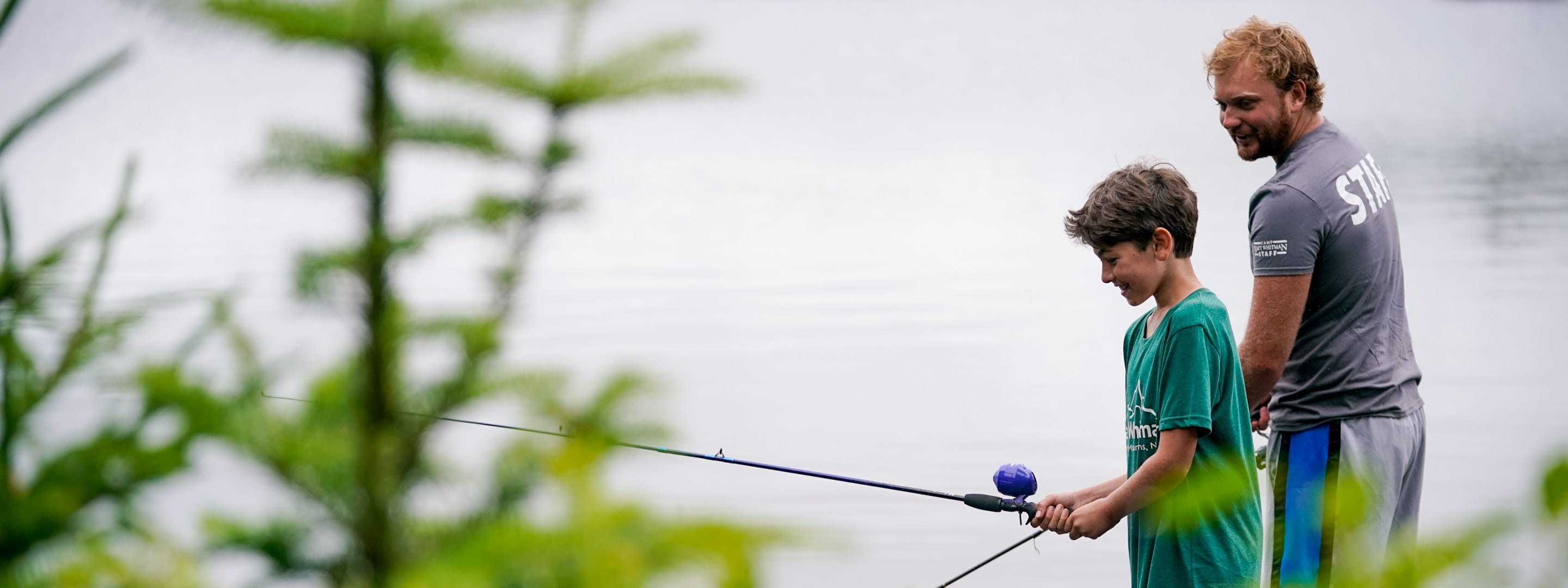 a camper and instructor fishing