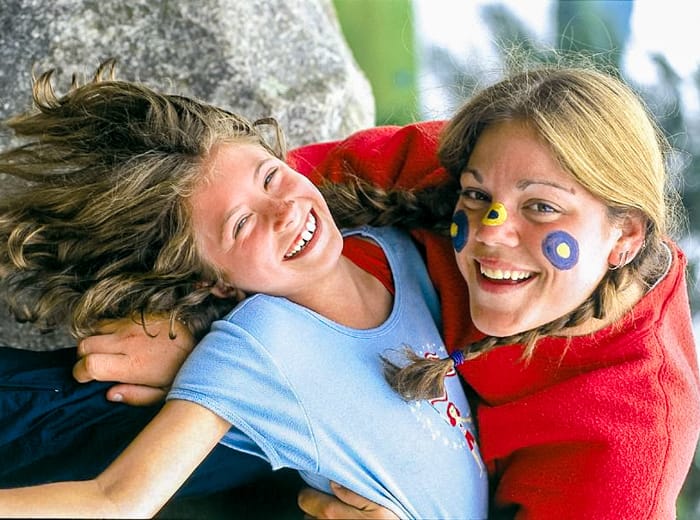 a young girl and a woman upside down smiling