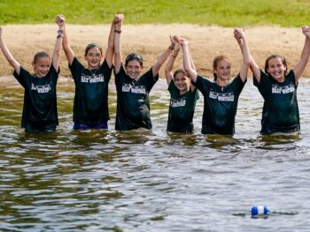 a group of girls wet in a lake