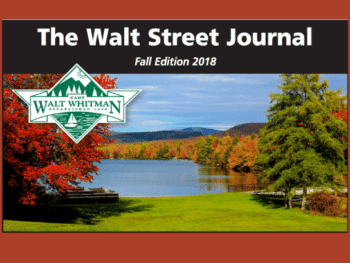 picturesque view of a lake with surrounding tree of chaning color with a caption 'the walt street journal'