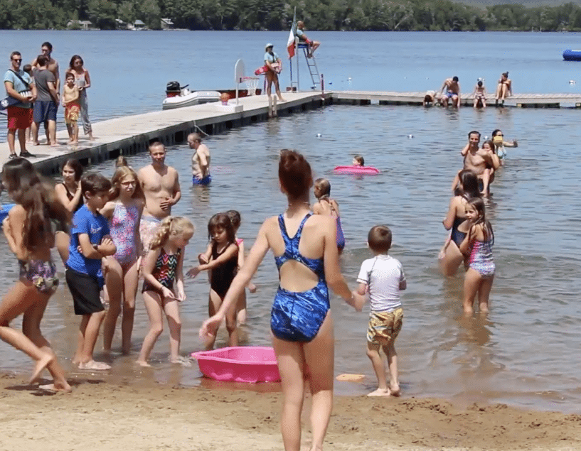 family in the lake at Camp Walt Whitman