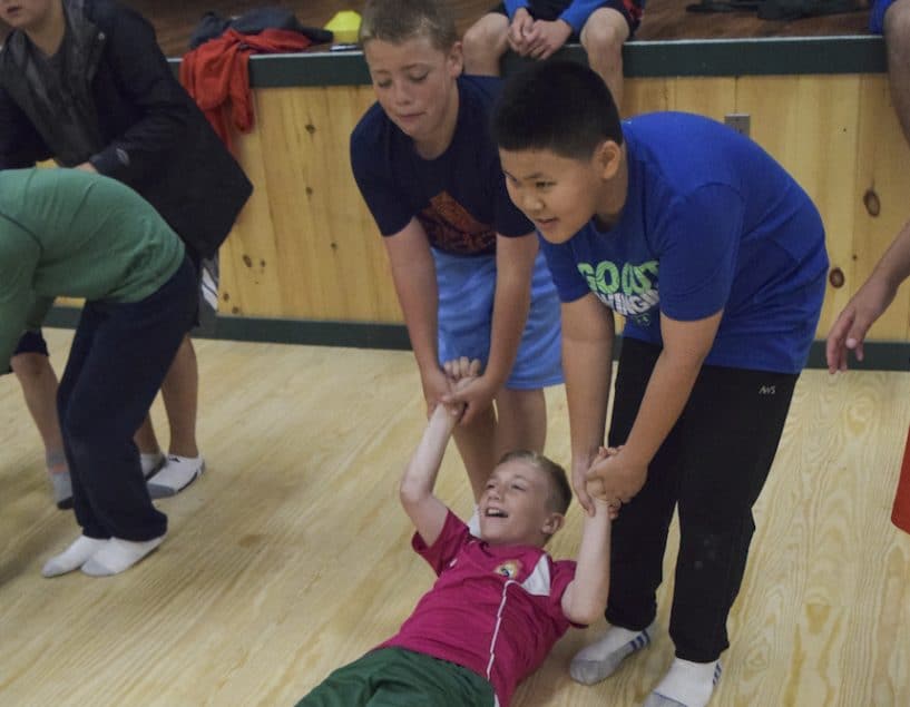 Camp councelor taking care of a sick child while at Camp Walt Whitman 