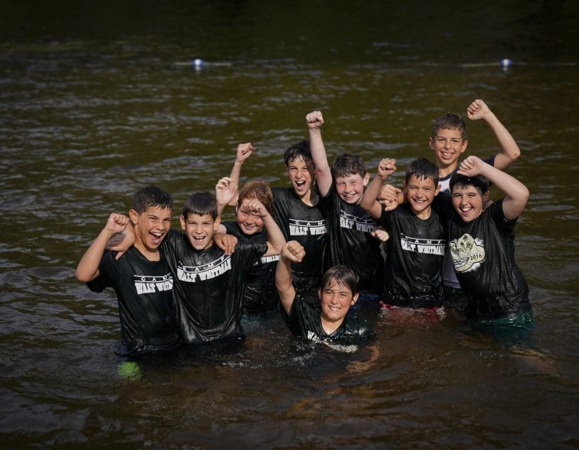 Friends swimming in the lake at Camp Walt Whitman