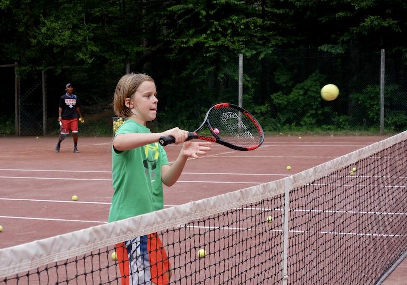 young girl playing tennis